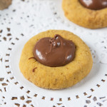 These Pumpkin Nutella Thumbprint Cookies are little bites of heaven. Spiced cookies, baked until slightly crisp, with gooey, rich Nutella spooned into the middle make these cookies simply irresistible!