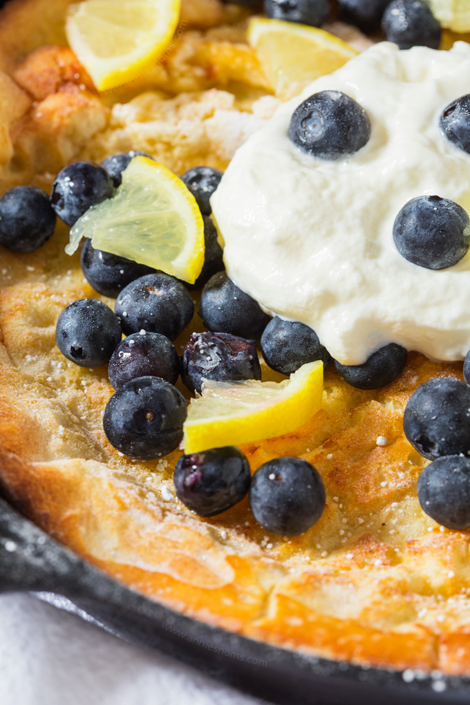 This light and fluffy Dutch Baby Pancake is infused with lemon and baked until golden. Topped with cream, blueberries and lemon it makes for a fab breakfast!