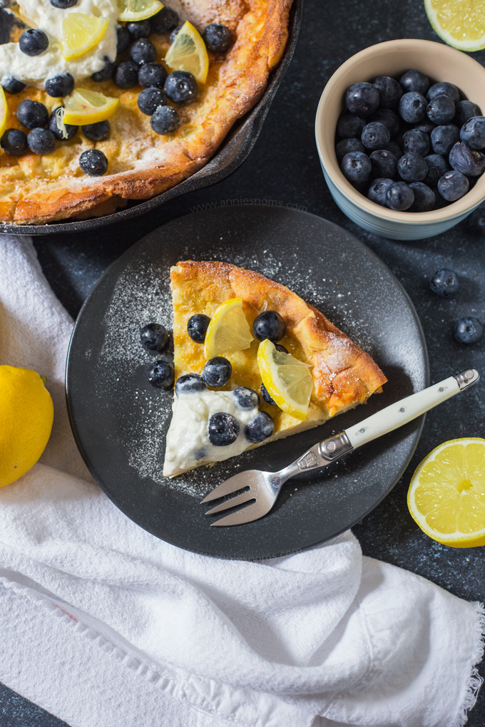 This light and fluffy Dutch Baby Pancake is infused with lemon and baked until golden. Topped with cream, blueberries and lemon it makes for a fab breakfast!