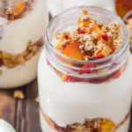 These Peach Parfaits are made with creamy Greek yoghurt, sweet peaches and crunchy granola; light and tasty, you decide whether these are breakfast or dessert!