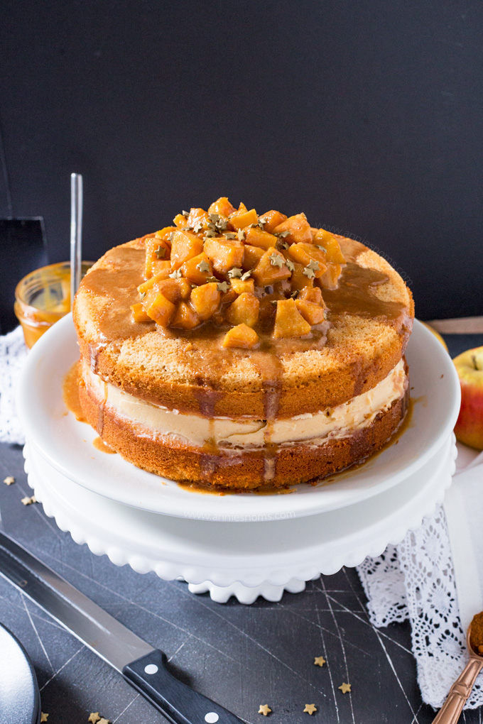 This Caramel Apple Layer Cake is Autumn in cake form! A lightly spiced cake, with sweet frosting and caramel apples piled high on top; this is one seriously delicious and easy to make showstopper! 