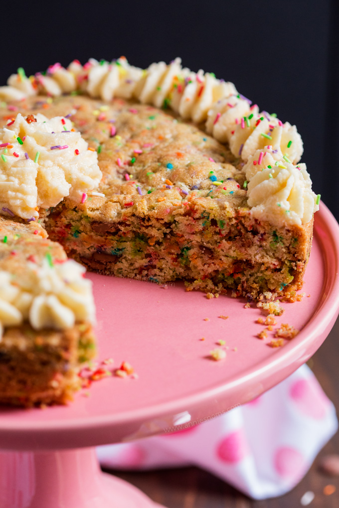 This thick and chewy cookie is filled with funfetti and milk chocolate chips and then baked in a cake pan to create a twist on traditional birthday cake! Decorated with buttercream and funfetti, it's a fantastic alternative to a bog standard cake!