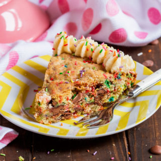 This thick and chewy cookie is filled with funfetti and milk chocolate chips and then baked in a cake pan to create a twist on traditional birthday cake! Decorated with buttercream and funfetti, it's a fantastic alternative to a bog standard cake!