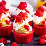 These Lemon and Raspberry Pavlova Cupcakes marry together soft, fluffy lemon cupcakes with lemon curd, frosting, meringue, raspberries AND raspberry sauce to create one seriously divine cupcake!